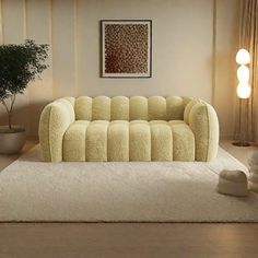 a living room filled with furniture and a potted plant on top of a rug