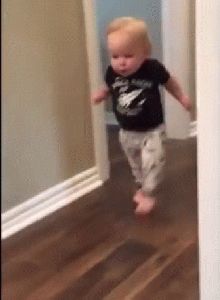 a toddler is running through the hallway