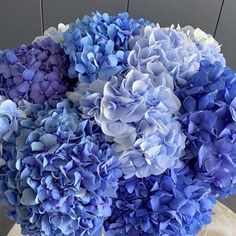 a vase filled with purple and blue flowers