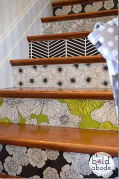 the stairs are decorated with floral wallpapers and black and white polka dot curtains