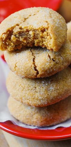 three cookies stacked on top of each other in a red plate with white napkins