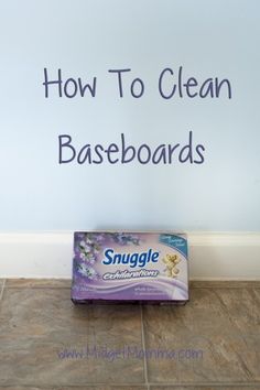 a box of snuggle clean wipes sitting on the floor in front of a wall