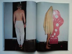 an open book with pictures of men in white pants and no shirt on the pages