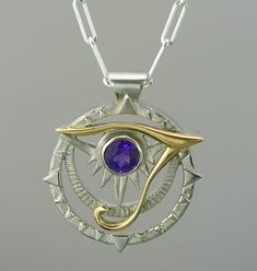 This egyptian pendant is made with sterling silver and 14 k solid gold ; this represent a unique  motif of eye of horus, a well-know egyptian symbol. It is very original, drawn and made by the artist. A perfect blend of past and present,  it is a one-of-a-kind jewel which will pass the test of time. A ideal present  for birthday(anniversary), Mother's Days, wedding, Christmas or to offer itself to oneself! pendant dimension : 2 cm you can choose between the amethyst stone or blue topaze, you can order also with a different stone if you like, don't hesitate to contact me! matching ring : https://www.etsy.com/ca/listing/512962240/women-ring-egyptian-ring-eye-of-horus?ref=shop_home_active_2 Because the environment means a lot to me just like you, all my jewelry is sent with the recyclable mat Unique Sterling Silver Evil Eye Jewelry, Egyptian Jewelry Modern, Gringotts Vault, Egyptian Ring, Egyptian Inspired Jewelry, Egyptian Pendant, Egyptian Accessories, Egypt Jewelry, Present For Birthday