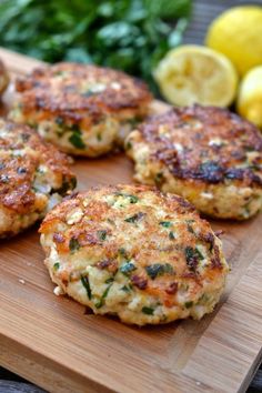 crab cakes on a cutting board with lemons in the background