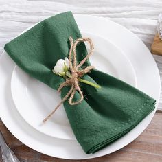 a white plate topped with a green napkin