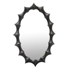 a circular mirror with spikes on the side and an oval frame in the middle, against a white background