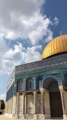 the dome of the rock is on top of an ornate building with columns and arches