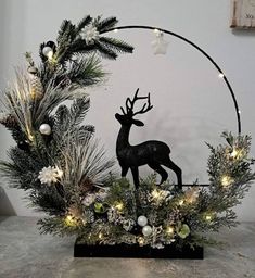 a christmas wreath with lights and a deer