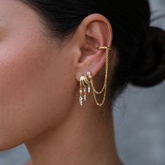 Unleash your inner edge with the Siren Double Chain in Gold Plated. This striking accessory features a chunky, irregular cuff designed to be worn on the lower helix, adding a bold touch to your look without the need for multiple piercings. The cuff is connected by two delicate chains that drape elegantly, creating a dramatic layered effect that instantly elevates your style. With only one piercing needed, the Siren Double Chain Cuff offers a versatile and statement-making addition to any ear sta Earring Cuff Chain, Helix Jewelry, Cuff Earring, Multiple Piercings, The Siren, September Birthstone Jewelry, Gold Ear Cuff, August Birthstone Jewelry, Ear Stack