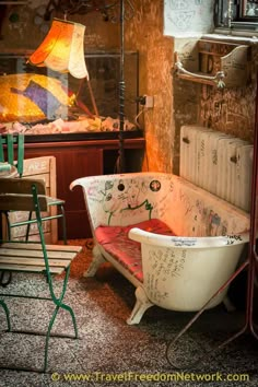 an old bathtub with writing on it in the middle of a room filled with furniture