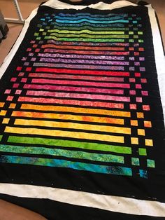 a multicolored quilt sitting on top of a table