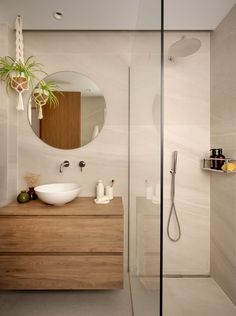 a bathroom with a sink, mirror and shower stall in it's side wall