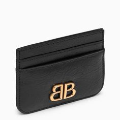 Black lambskin card case by Balenciaga features an antiqued gold logo, four card slots and a banknote pocket. Bb Logo, Black Balenciaga, Woman Card, Balenciaga Black, Popular Bags, Leather Card Holder, Balenciaga Bag, Gold Logo, Card Holder Leather