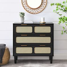 a black and white dresser sitting next to a mirror