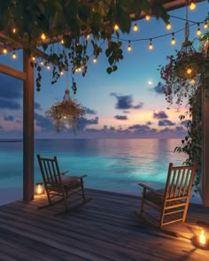 two rocking chairs sitting on top of a wooden deck next to the ocean at night