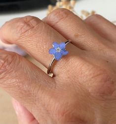 This handcrafted ring is light and comfortable on your finger and made with real pressed forget me not flower and quality uv resin. It is not tarnish and long lasting. All flowers are home grown, self dried, pressed by me in my home workshop. Forget me not flowers symbolise true love and remembrance, making them the perfect flower to give someone very special or being missed. It can be also a reminder of our loved ones that we lost. It is not only a simple and cute design but also a great keepsake gift.  They are great gift for Birthday, Wedding, Valentines Day, Mothers Day, Christmas, Bridal shower or just lift up surprise gift. ❤️Handmade in Oxfordshire, UK - Ring material: Stainless Steel - Ring wearable size: adjustable - Flower size varies: 5mm-8mm - There are slight differences betwe Handmade Blue Flower Ring For Anniversary, Adjustable Blue Flower Ring, Adjustable Blue Flower Ring For Gifting, Adjustable Blue Flower Ring Gift, Forget Me Not Earrings, Forget Me Not Necklace, Forget Me Not Jewelry, Blue For Wedding, Forget Me Not Ring