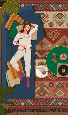 a woman laying on top of a rug next to a record player and an animal