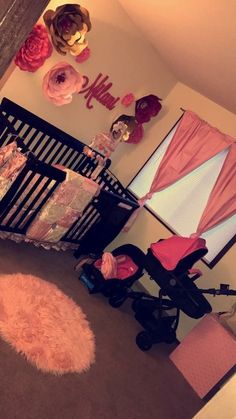 a baby's room is decorated with pink and gold accents, including a crib