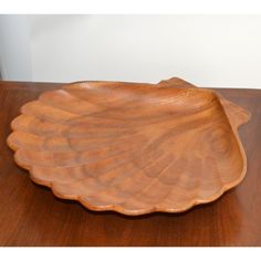 a wooden plate sitting on top of a wooden table