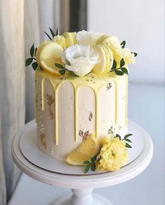 a white cake with lemons and flowers on top