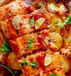 salmon and potatoes on a sheet pan with lemons, parsley and cilantro