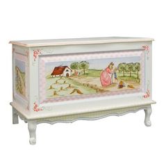 a painted chest with an image of a woman sitting on the ground in front of it