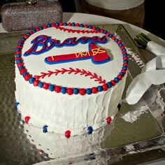 a baseball themed cake on a silver platter