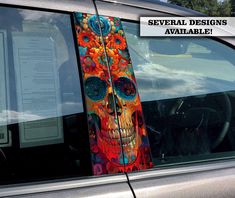 a car with a colorful skull painted on it's side window and the words severial designs available