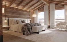 a bedroom with wooden walls and ceiling, white bedding and fur throw pillows on the headboard