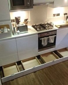 an open drawer in the middle of a kitchen