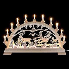 a lit up christmas scene with candles in the shape of a horse and sleigh