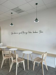 the interior of a restaurant with tables and chairs, along with a wall that says you can't get things like lunch time