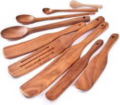 wooden utensils and spoons laid out on a white surface