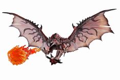 a toy dragon flying through the air with its wings spread