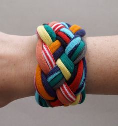 a person's arm with a multicolored bracelet on it