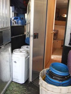 the inside of a trailer with several containers stacked on top of it