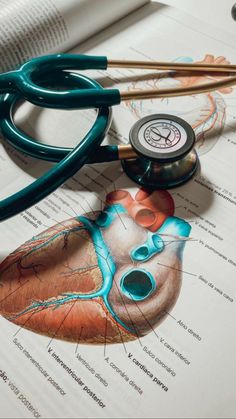 a medical stethoscope laying on top of an open book