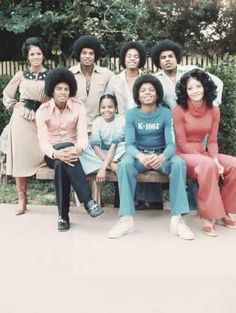 a group of people that are sitting on a bench