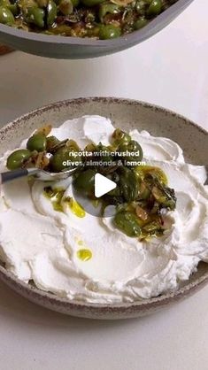 two bowls filled with food on top of a table