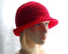 a mannequin head wearing a red crocheted hat