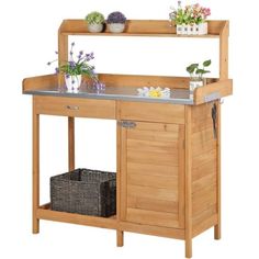 a kitchen island with two potted plants sitting on it's top and bottom shelf