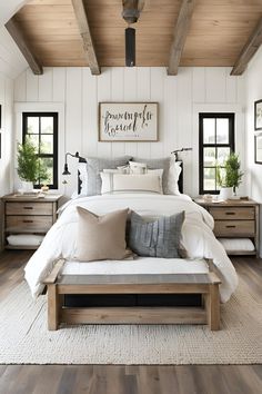 a bedroom with white walls and wooden beams, wood flooring, and a large bed