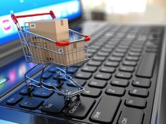 a shopping cart sitting on top of a laptop keyboard