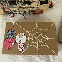 a hello kitty spiderweave card on a table