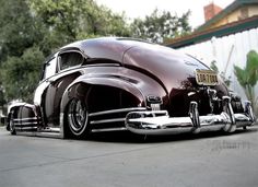 an old car parked in front of a building with the words las moonlight written on it