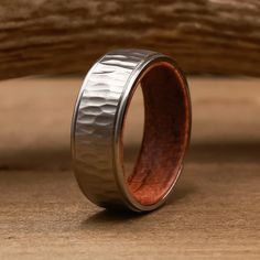 a wedding ring made out of silver and wood