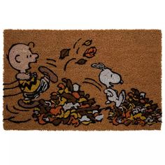 a door mat with snoop and charlie the peanuts character throwing leaves at each other on it