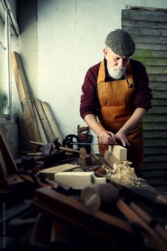 an old man working with wood in his workshop