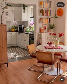 a kitchen with a table and chairs in it